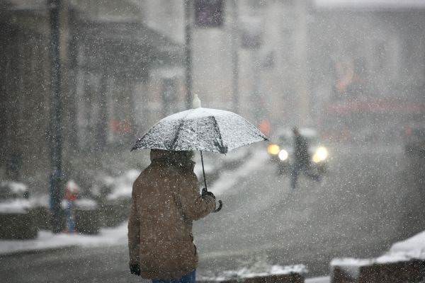 20 man using transparent umbrella during snow storm street