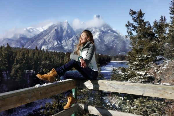 21 sports girl sitting on wooden fence