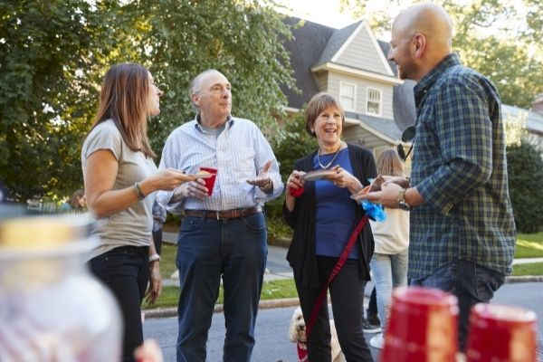 20 middle aged senior neighbours talking block