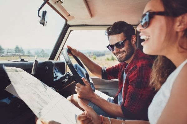 happy-young-couple-map-car-smiling-how-was-your-trip