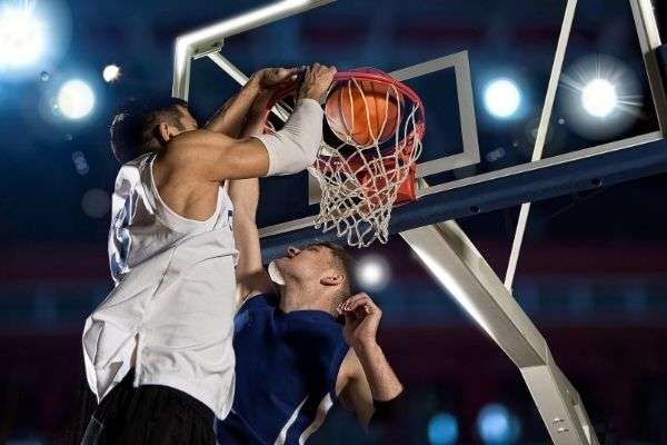 two basketball players action gym ball dunk