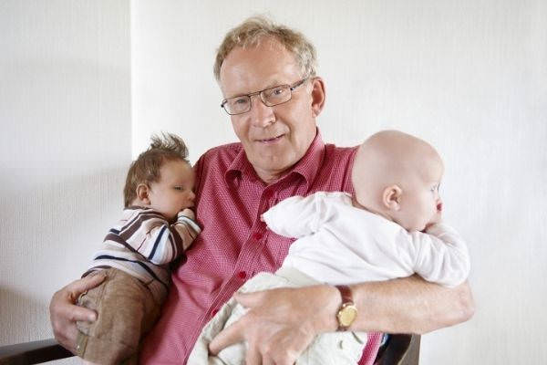 grandfather holding two babies
