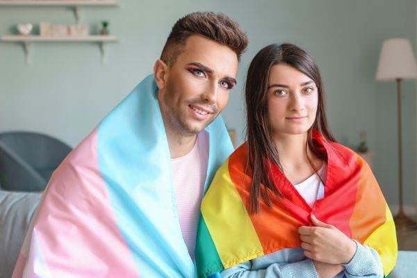 portrait-young-transgender-couple-flags-home-what-to-say-when-someone-come-out-as-transgender