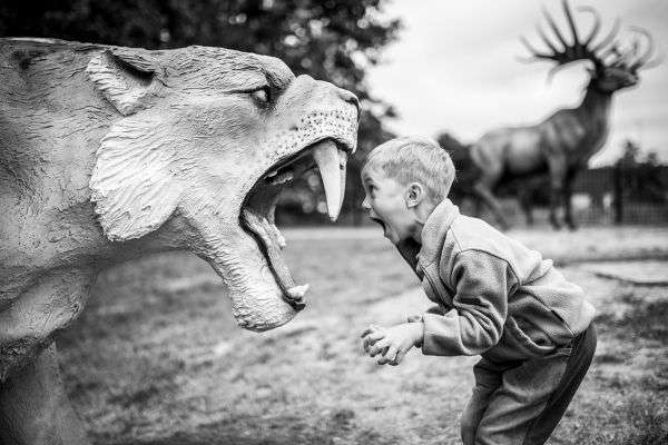 boy shouting artificial sabertoothed tiger black and white photo