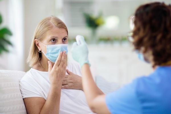 doctor examining sick patient face mask