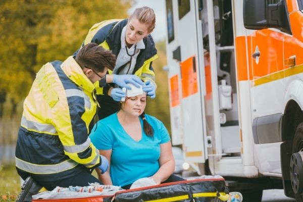 emergency medics dressing head wound injured