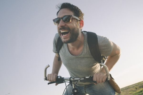 young man bicycle having outdoor fun wearing sunglasses