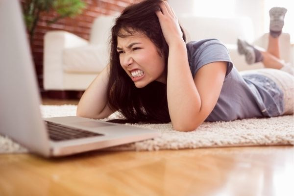 close asian angry woman using laptop