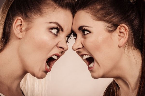 two agressive women having argue fight head to head