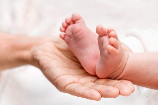 baby feet parent hands maternity happy