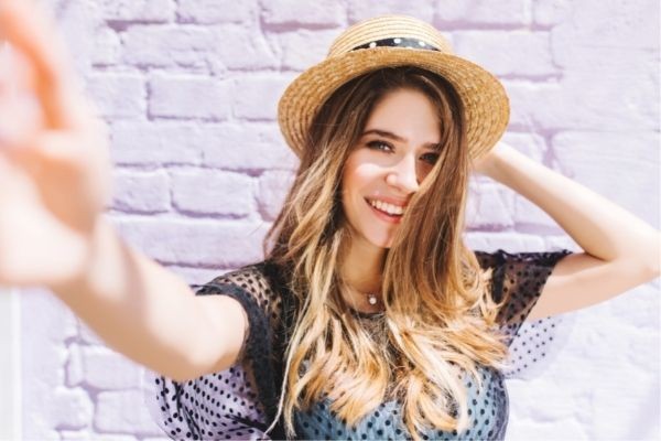 01 close portrait happy girl midback length wearing hat