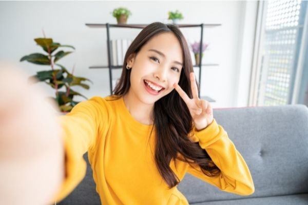 04 pretty young asian female big smile wearing yellow long sleeves