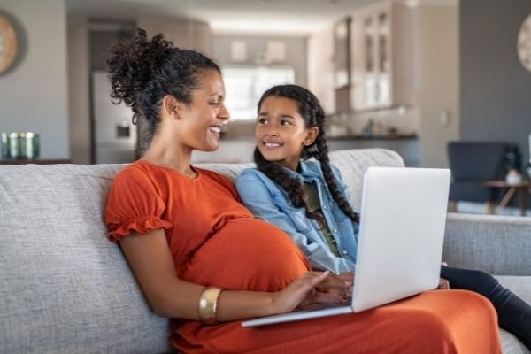 pregnant-black-woman-working-on-laptop-congrats-on-maternity-leave