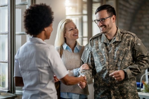 happy military man shaking hands female