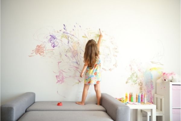 curly cute little toddler girl painting