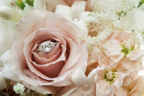 engagement ring on top of flower