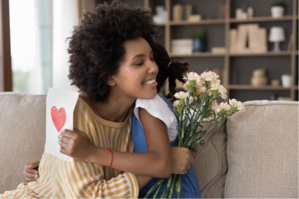 loving african daughter congratulates young mom