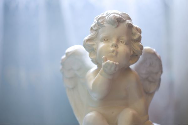 statue angel sending air kiss light on top