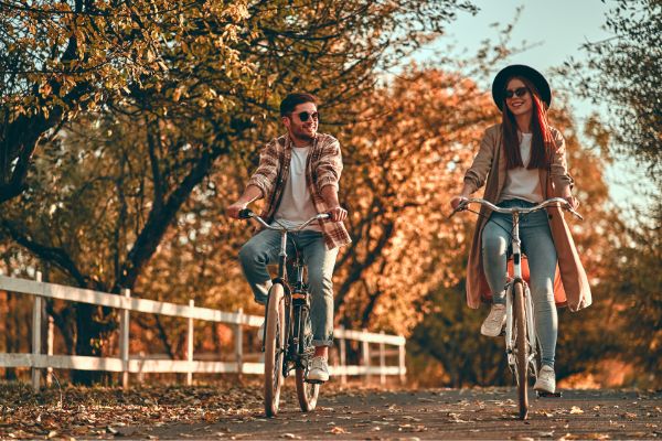 12 young couple bicycles park autumn time