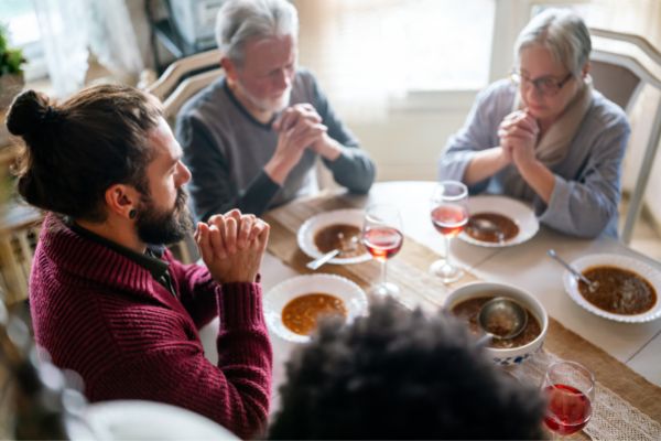 family religious concept group multiethnic people praying around table
