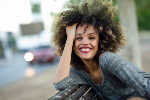 young mixed woman afro hairstyle smiling