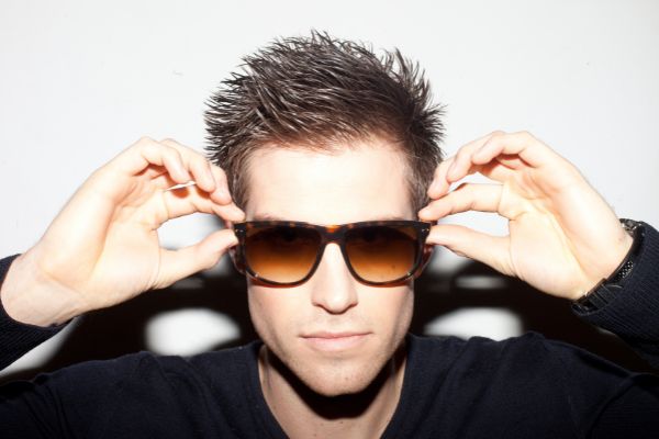 trendy young man spiky hair wearing brown sunglasses