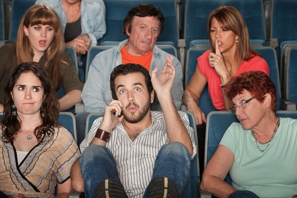 loud bearded man on phone annoys people on movie theater