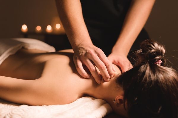 mens hands make therapeutic neck massage
