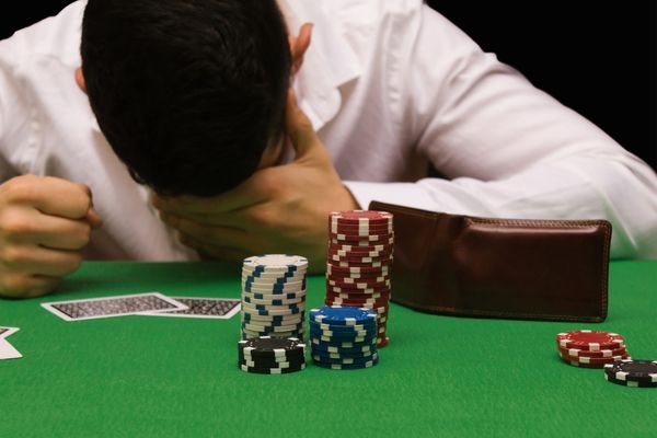 devastated gambler man losing money playing poker