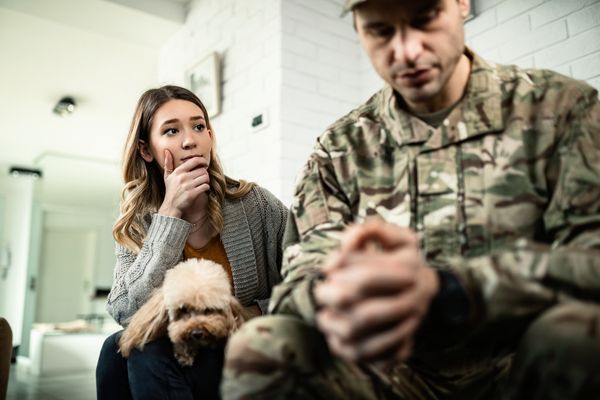 young woman looking her depressed military husband