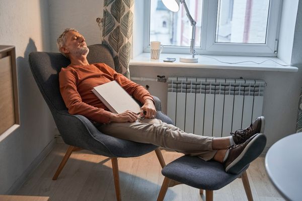 male reader taking nap comfortable armchair