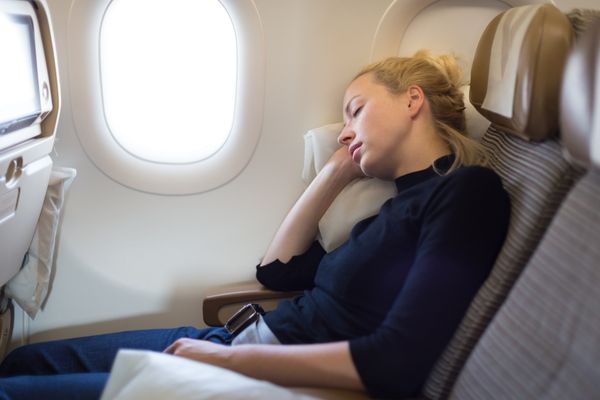 Tired lady napping traveling by airplane