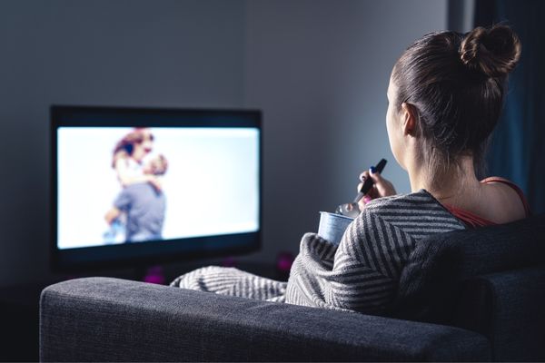 lonely woman watching romantic movie eating ice cream