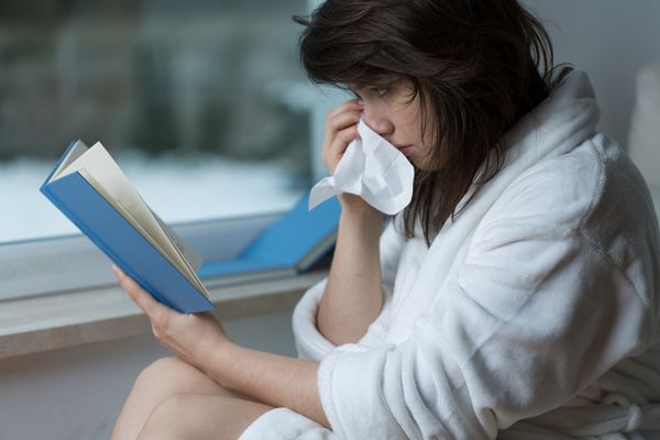 woman reading romance and crying