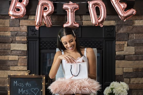bride to be opening a bridal shower present