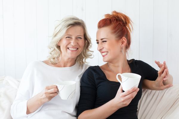 mother daughter sitting having coffee together