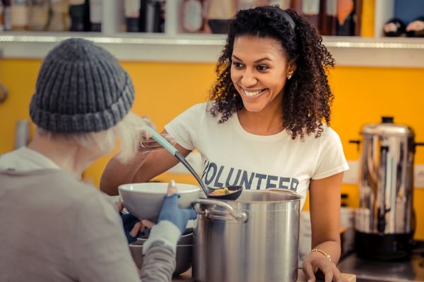 nice friendly woman smiling volunteering food