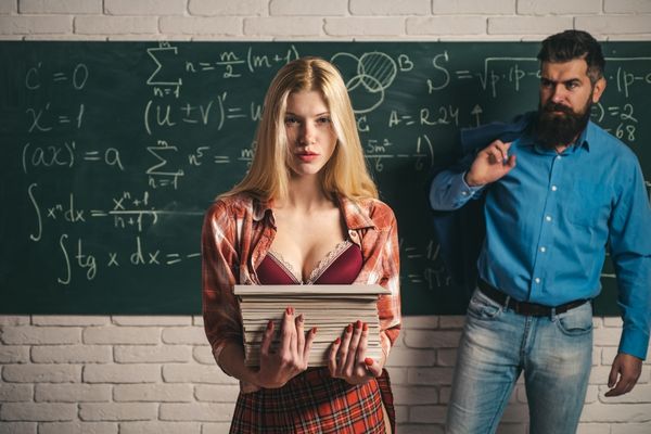 woman carrying books professor near blackboard rpg