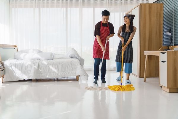 asian young couple having fun household chores