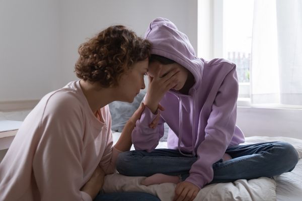 04 worried mom comforting depressed crying teen daughter