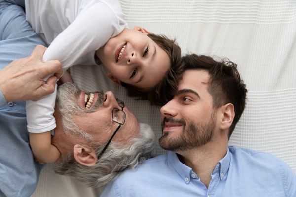 grandson embrace grandfather laughing father enjoy moments