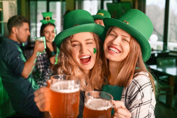 women beer celebrating St. Patrick's Day pub clover green hats