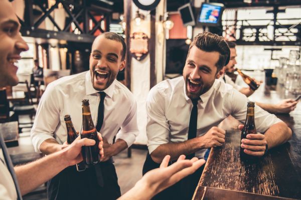 drinking beer in bottle talking laughing in bar