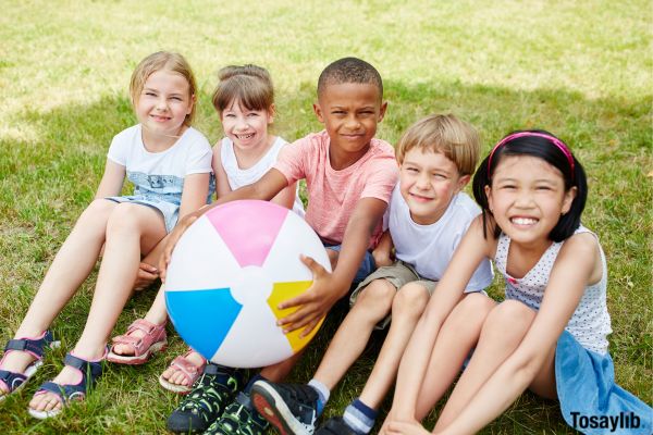 Group of young students Summer camp with beach ball