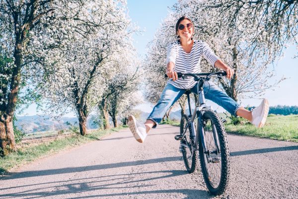 woman riding bike spreading legs countryside