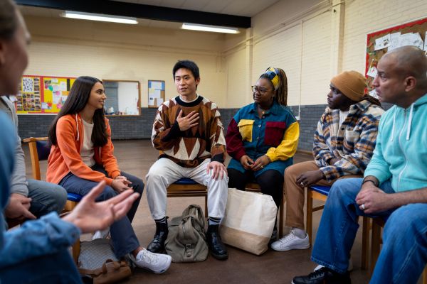 Man self introducing Into Mental Health mixed racial Group