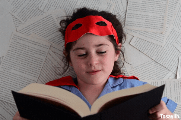 Superhero girl reading a book for writing prompts