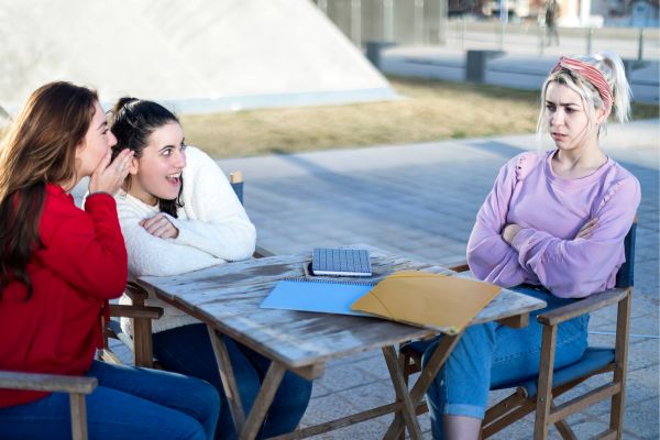 Toxic friends Gossiping About a friend looking sad annoyed