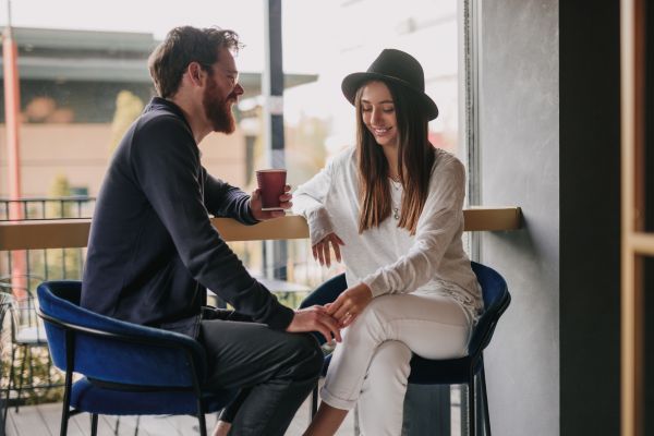 young couple flirty first date self introducing in cafe