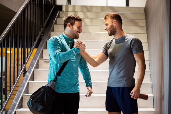 friends shake hands encourage each other after workout